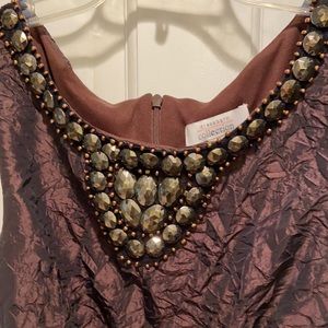 Brown dress with beading on the front neckline.